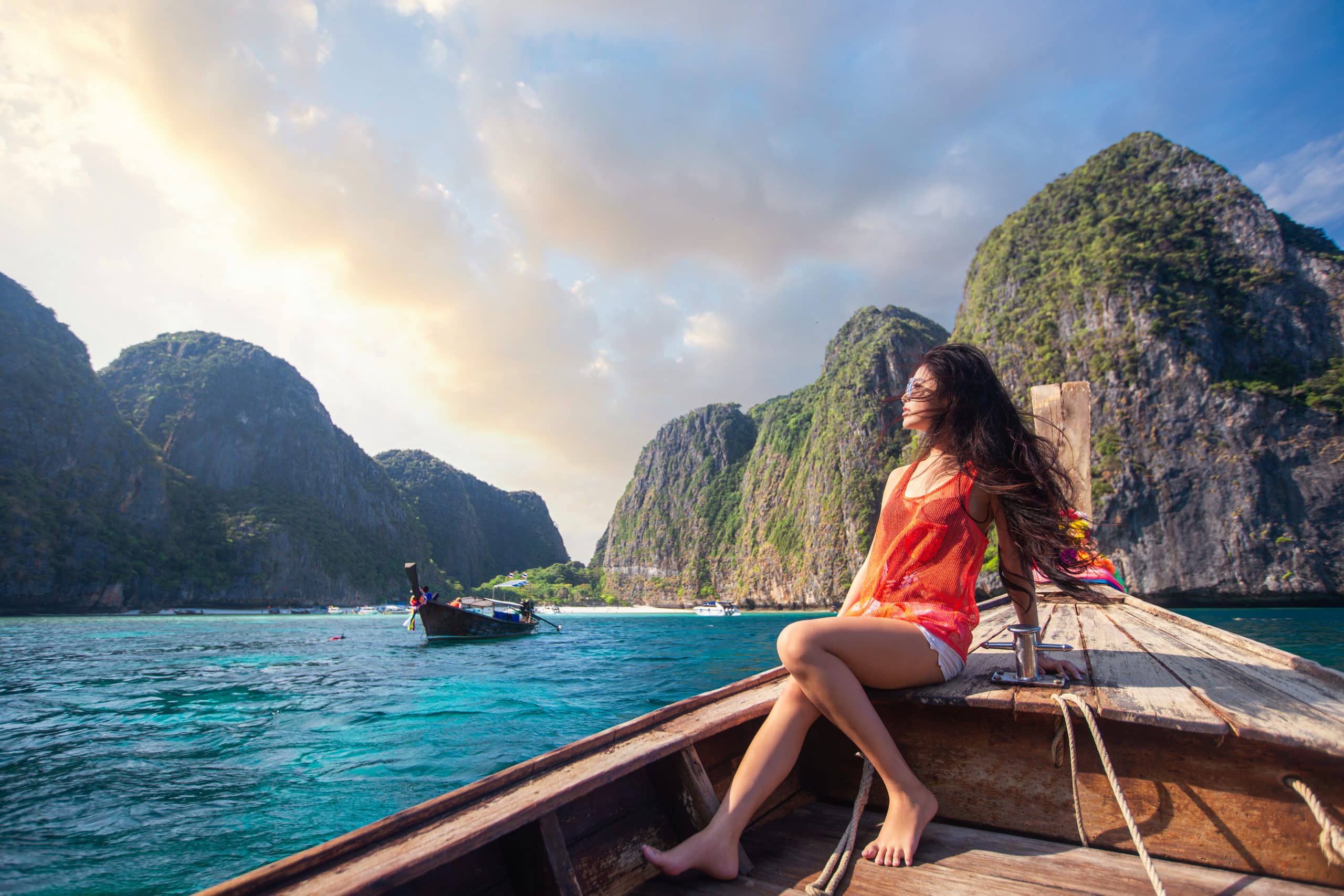 asian travel woman relax traditional long tail boat with maya bay background phi phi scaled