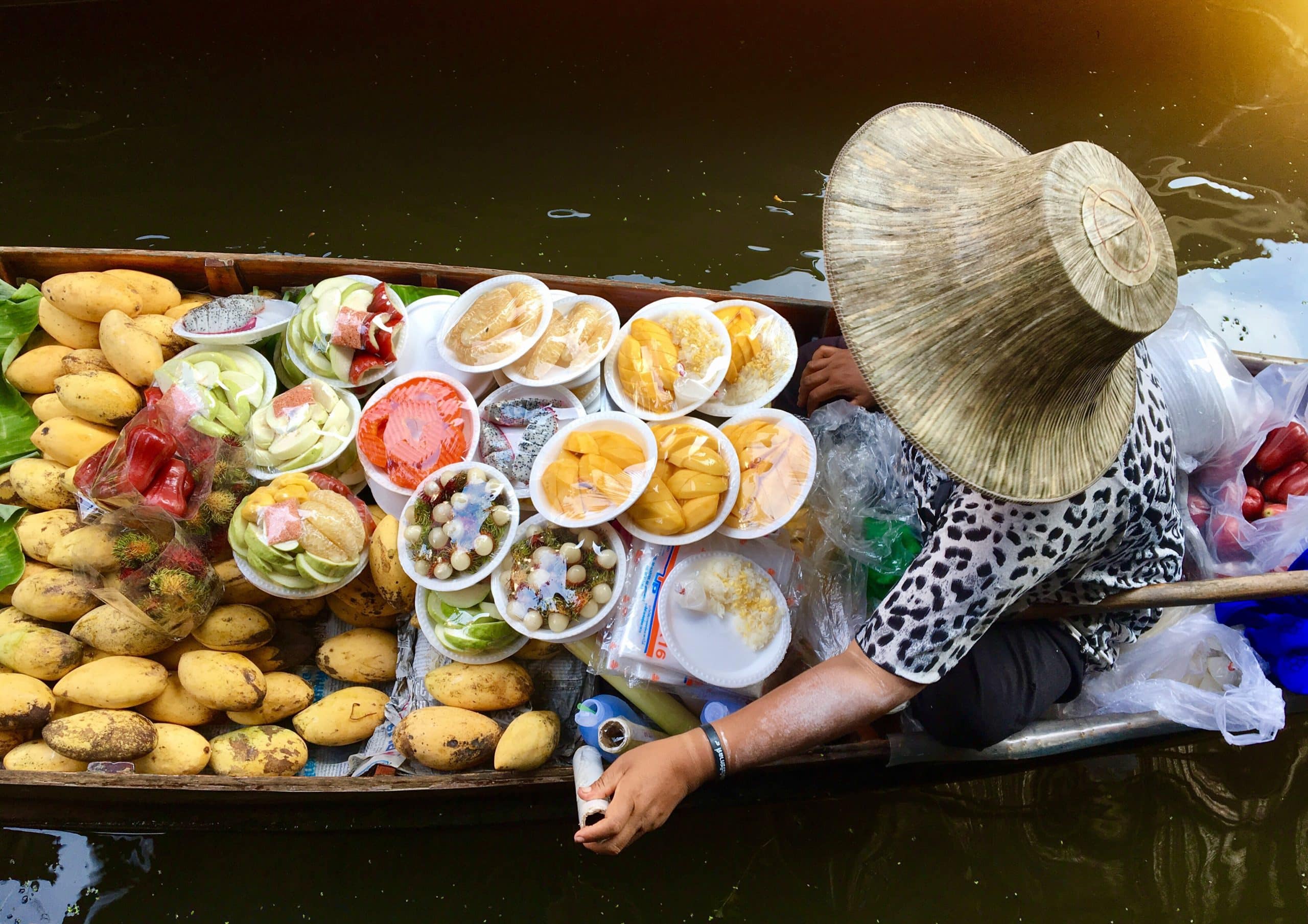 high angle view woman selling food boat lake scaled